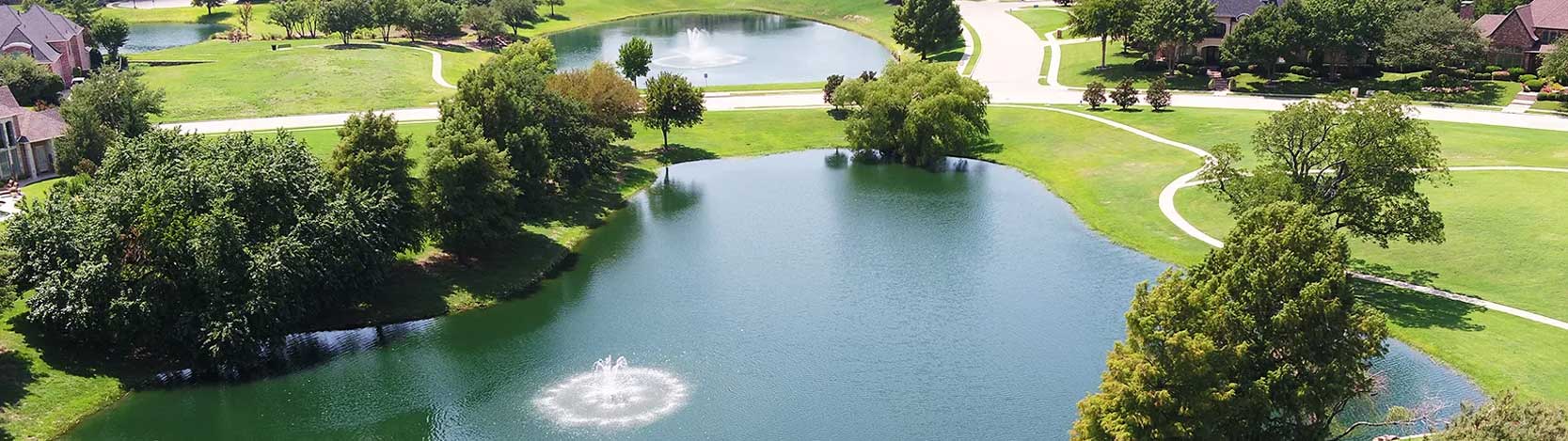 Landscape view of lakes and fountains in the Stonebridge Ranch Community